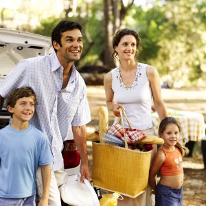 Family Standing Behind a Car at a Picnic Spot