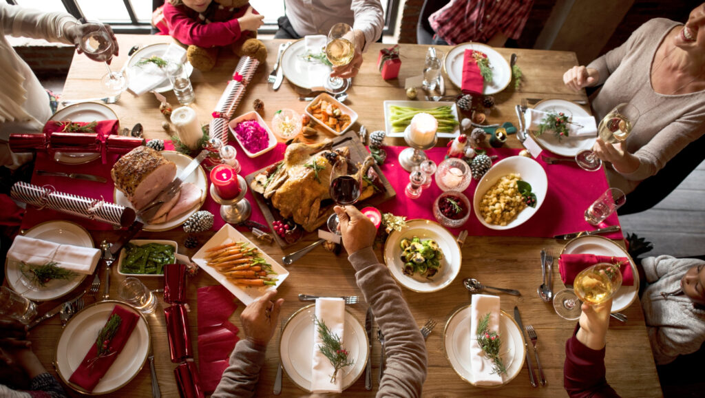 A festival dining table with food and decorations.