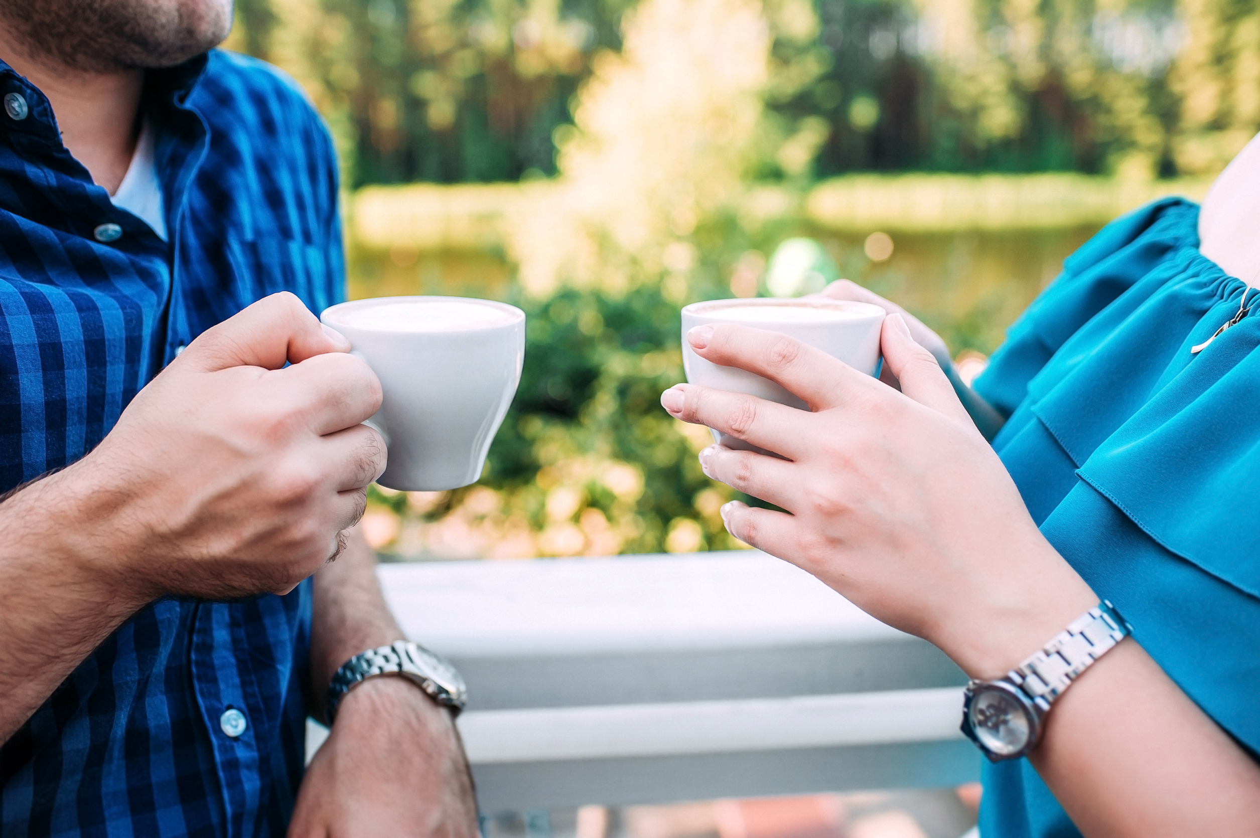 Two hands holding coffee cups